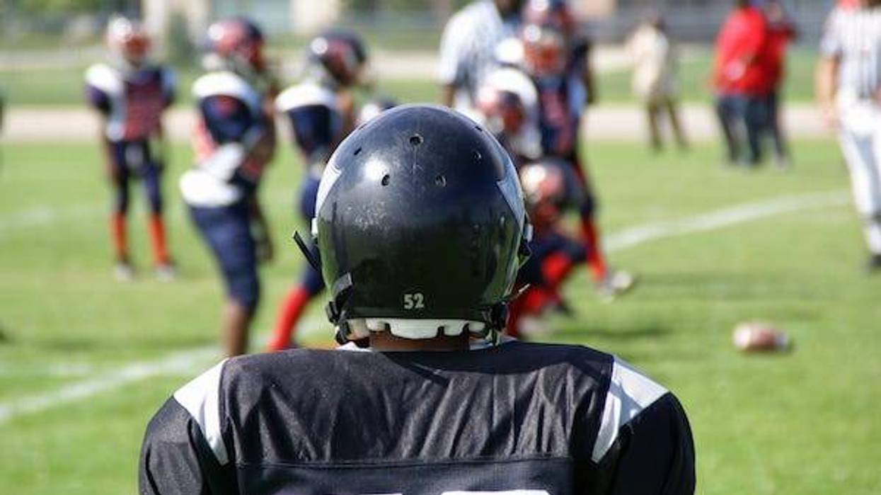 Football player watching the game from the sidelines