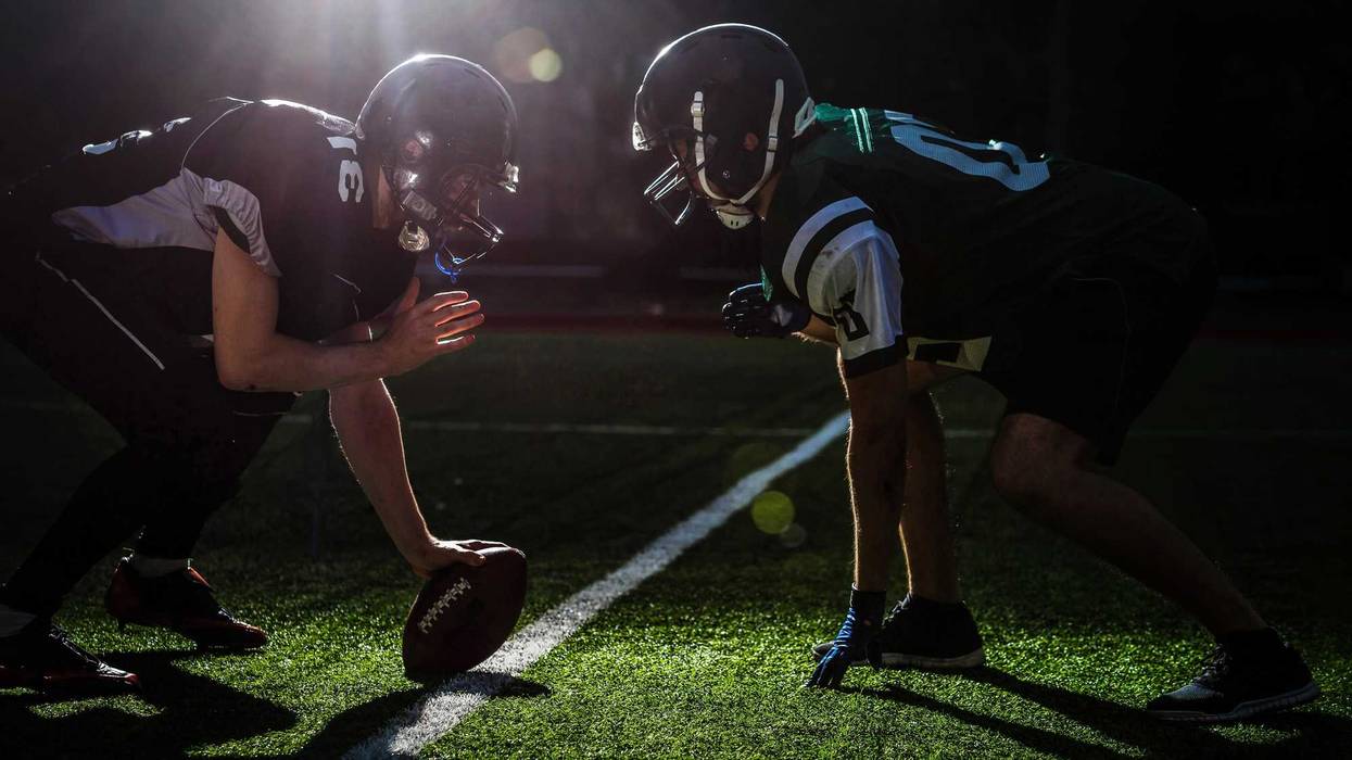 Football players on modern field at night