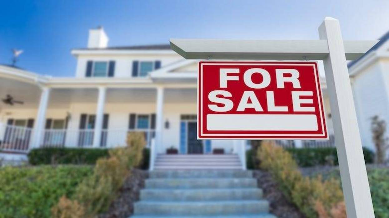 “For Sale” sign in front of a home