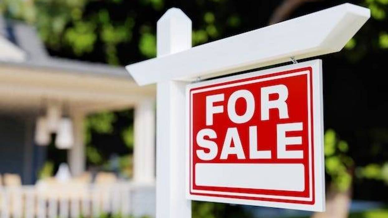 “For Sale” sign in front of home