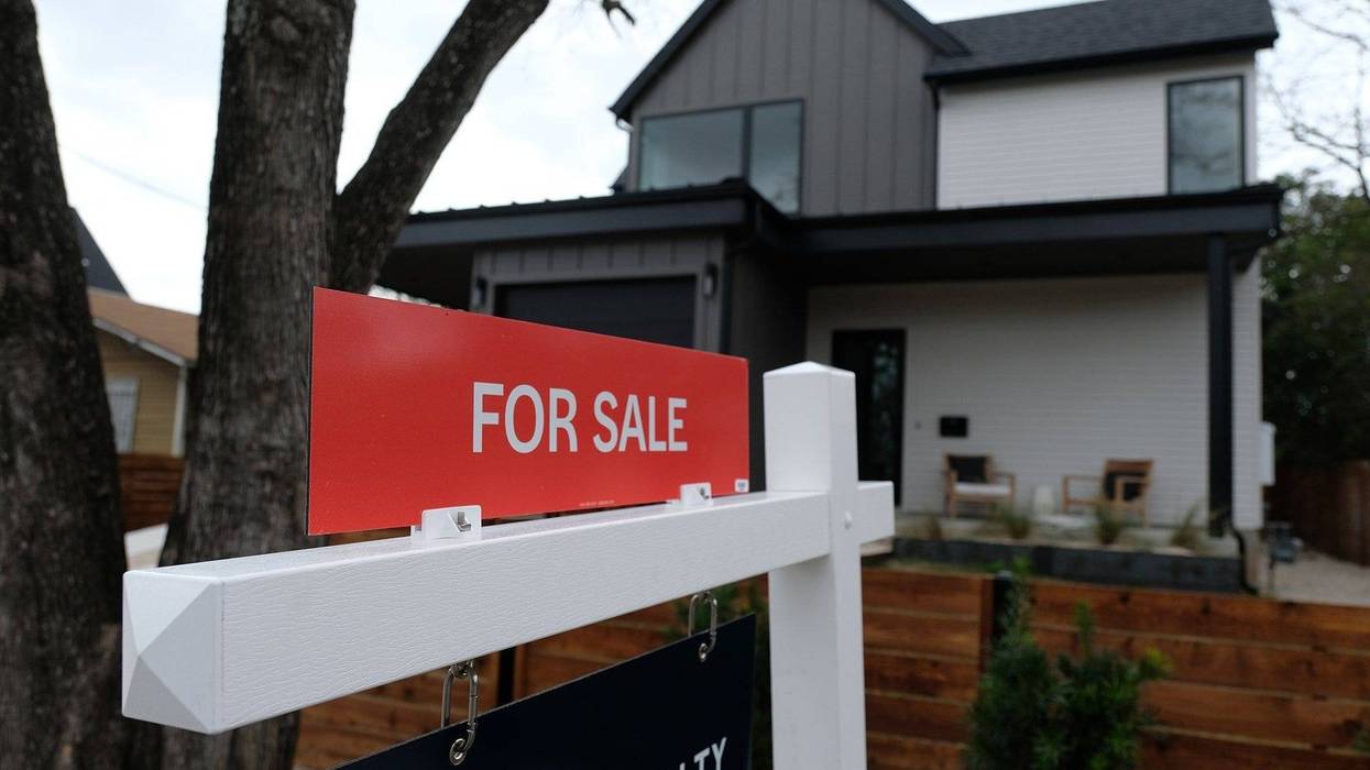 For Sale sign in front of house