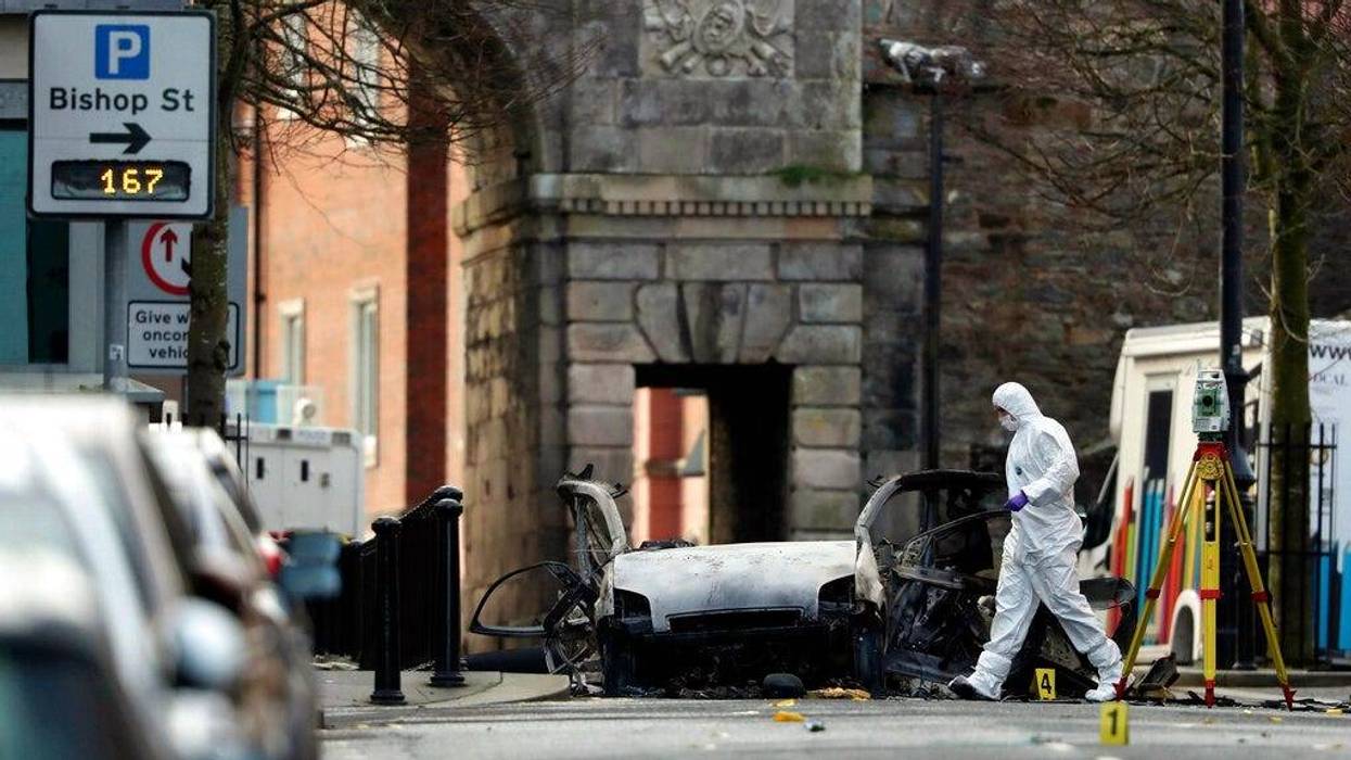 Forensic investigators at the scene of a car bomb blast on Bishop Street in Londonderry, Northern Ireland, Sunday, Jan. 20, 2019.