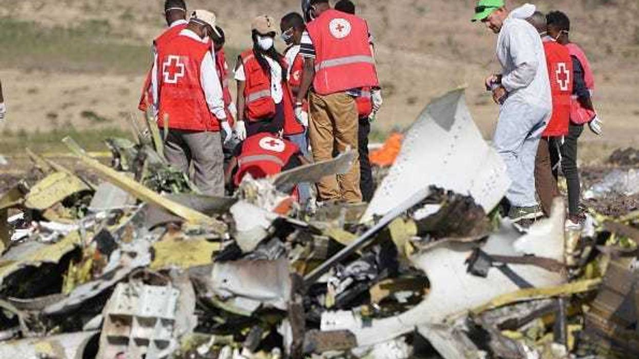Forensics investigators and recovery teams collect personal effects and other materials from the crash site of Ethiopian Airlines Flight ET 302 on March 12, 2019 in Bishoftu, Ethiopia.