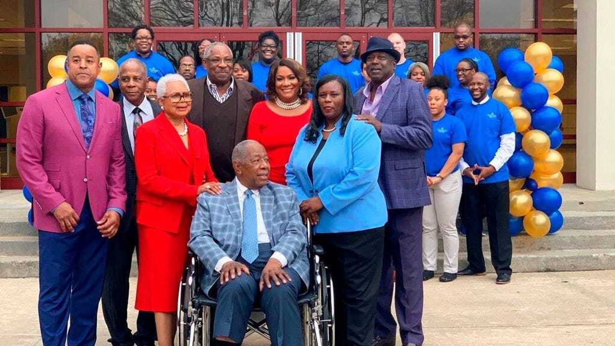 Former Atlanta Braves slugger Hank Aaron, center, is surrounded by family and friends as Atlanta Technical College celebrates his 86th birthday, Wednesday, Feb. 5, 2020 in Atlanta.