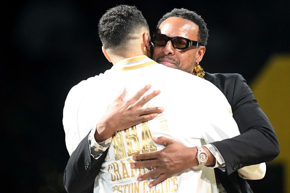 Former Boston Celtics, Paul Pierce, and Jayson Tatum #0 of the Boston Celtics embrace during the NBA Championship ring ceremony prior to the game against the New York Knicks at TD Garden on October 22, 2024 in Boston, Massachusetts