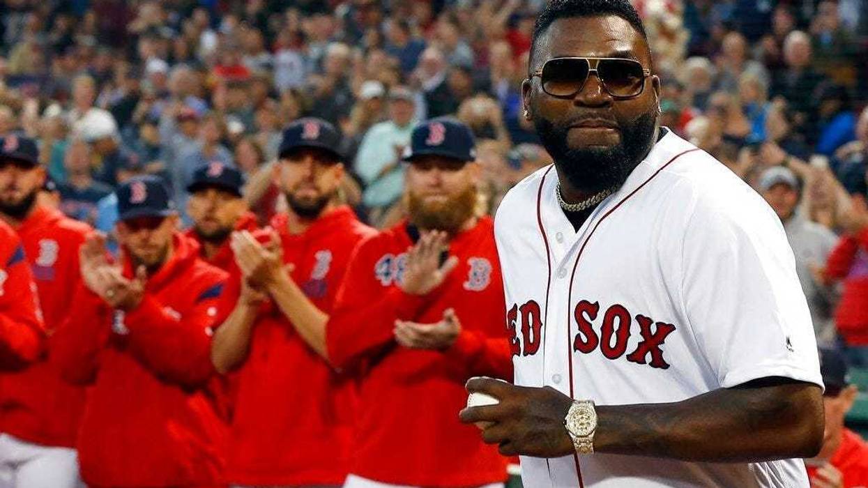 Former Boston Red Sox's David Ortiz comes onto the field to throw out a ceremonial first pitch before a baseball game against the New York Yankees in Boston, Monday, Sept. 9, 2019.