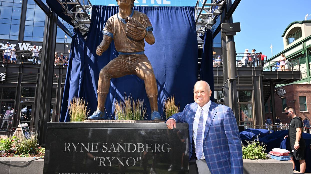 Former Chicago Cubs player and Hall of Famer Ryne Sandberg poses for pictures in front of his statue before a game against the New York Mets at Wrigley Field on June 23, 2024, in Chicago