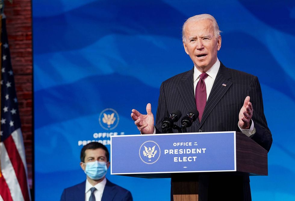 Former Democratic presidential candidate Pete Buttigieg (L) listens as U.S. President-elect Joe Biden announces his nomination during a news conference at Biden