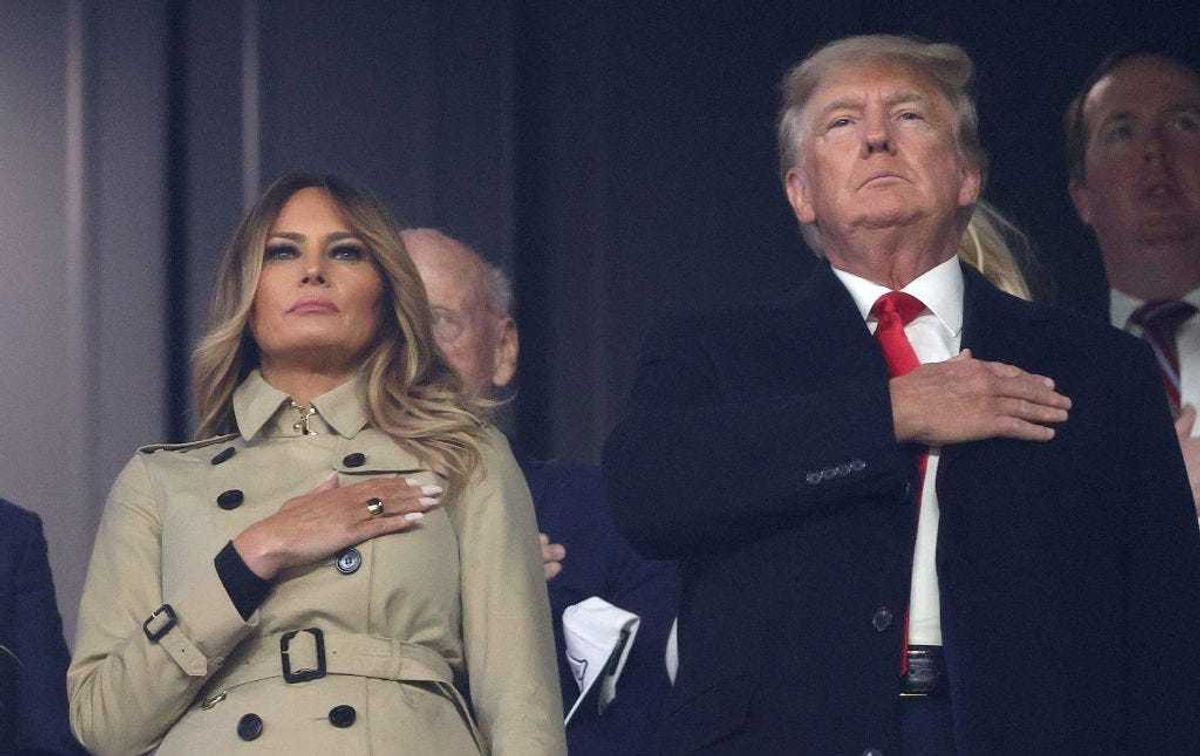Former first lady and president of the United States Melania and Donald Trump stand for the national anthem prior to Game Four of the World Series between the Houston Astros and the Atlanta Braves Truist Park on October 30, 2021 in Atlanta, Georgia. (Photo by Elsa/Getty Images)