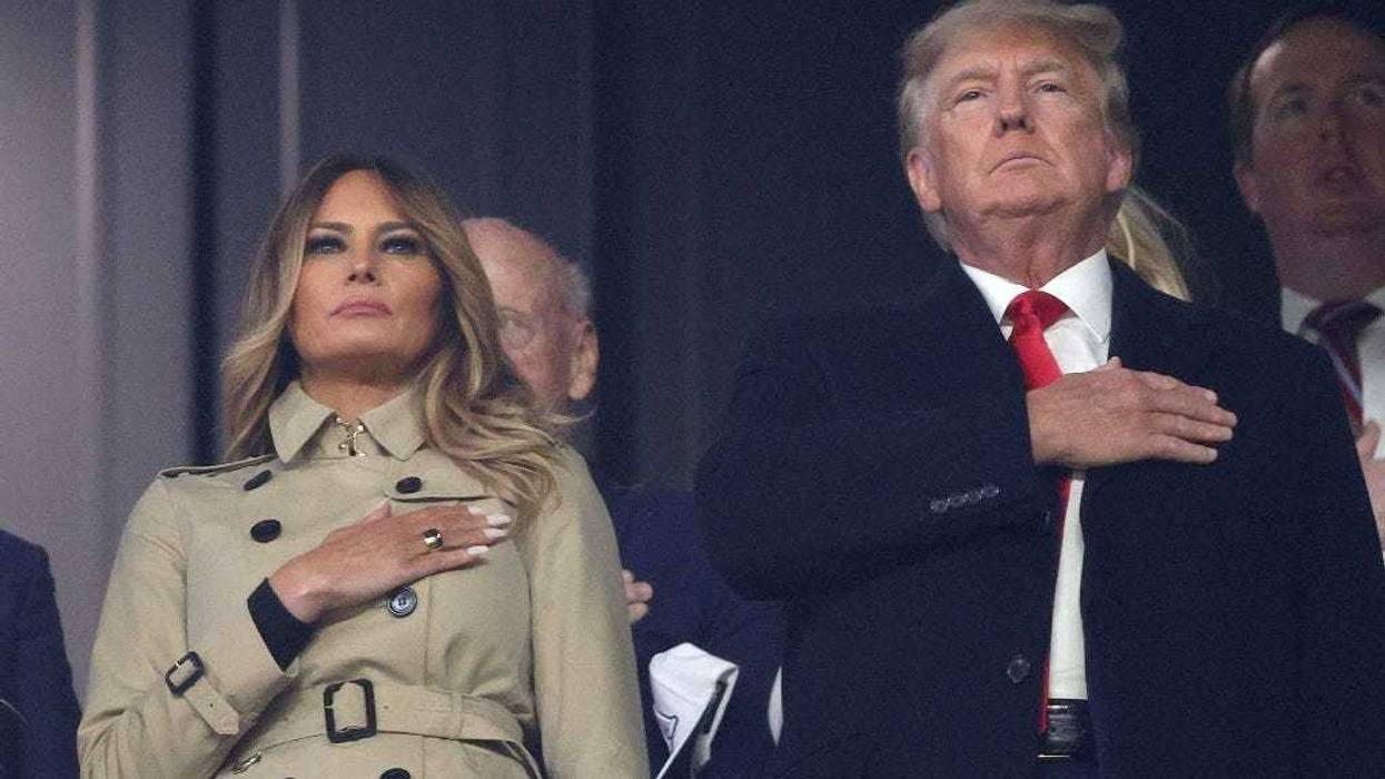Former first lady and president of the United States Melania and Donald Trump stand for the national anthem prior to Game Four of the World Series between the Houston Astros and the Atlanta Braves Truist Park on October 30, 2021 in Atlanta, Georgia. (Photo by Elsa/Getty Images)