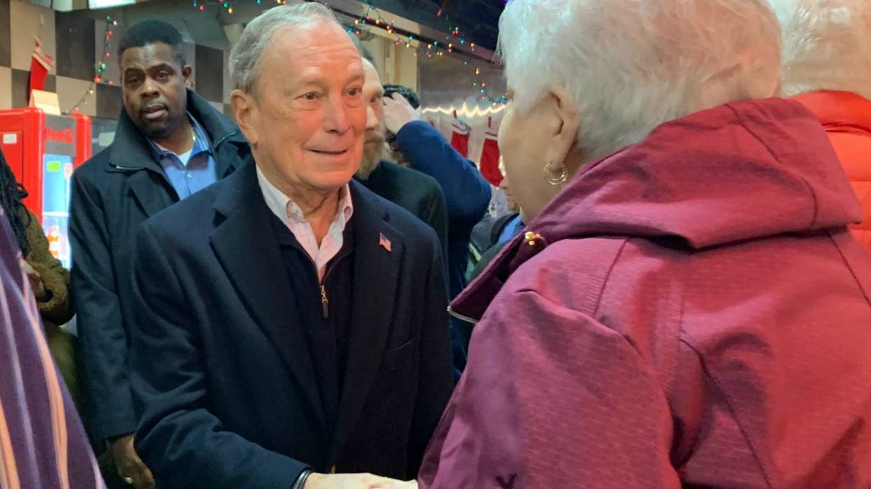 Former New York mayor turned Democratic presidential candidate Michael Bloomberg greets a woman at Reading Terminal Market.