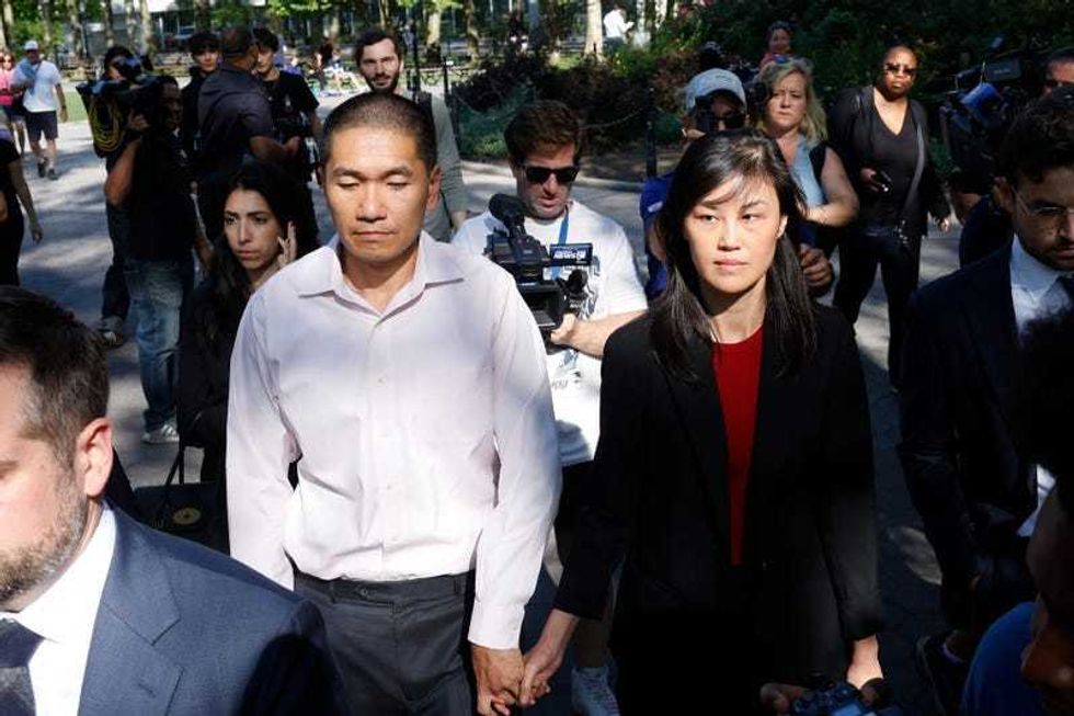Former NY Gov. Kathy Hochul aide Linda Sun (R), and her husband (L), Christopher Hu, leave Brooklyn Federal Court after their arraignment, Tuesday, Sept. 3, 2024, in New York. Sun is charged with being an aide to the Chinese government.