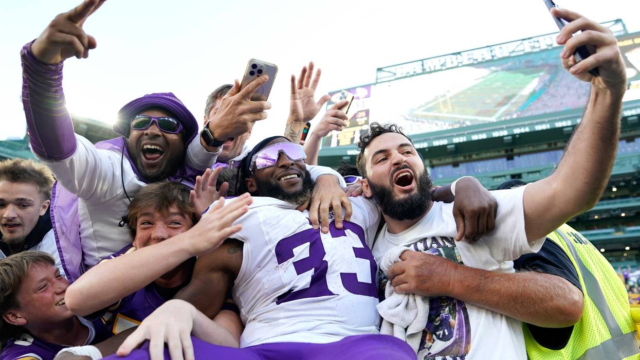Former Packer Aaron Jones #33 of the Minnesota Vikings celebrates with fans after defeating the Green Bay Packers at Lambeau Field on September 29, 2024 in Green Bay, Wisconsin.