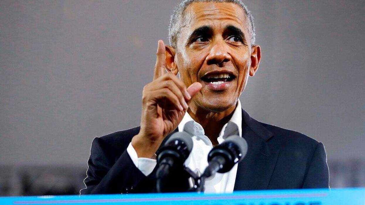 Former President Barack Obama steps on stage to speak during a campaign rally for Georgia gubernatorial candidate Stacey Abrams