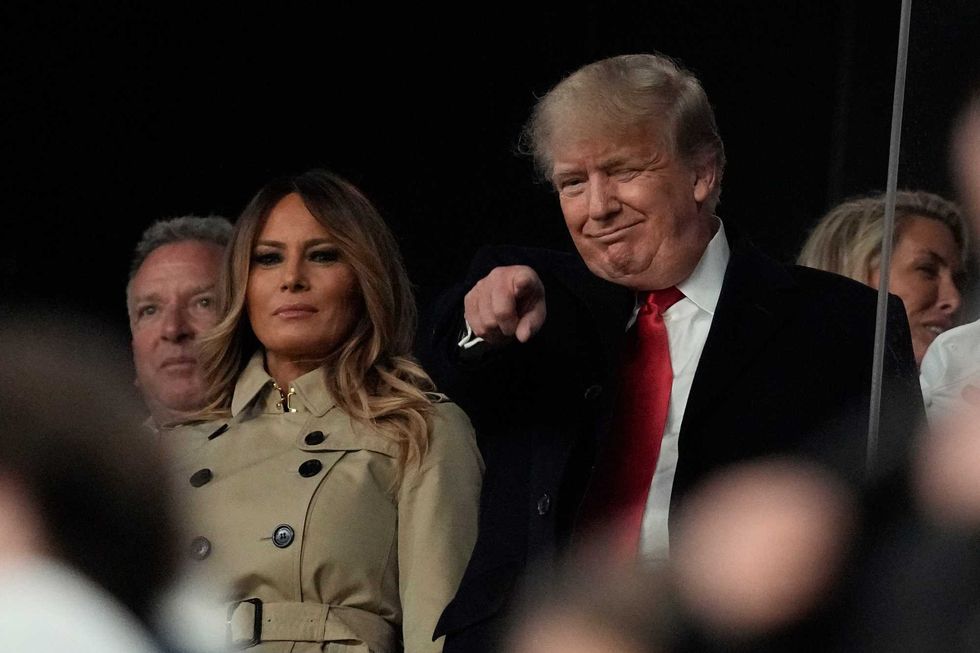 Former President Donald Trump and his wife Melania arrive for Game 4 of baseball