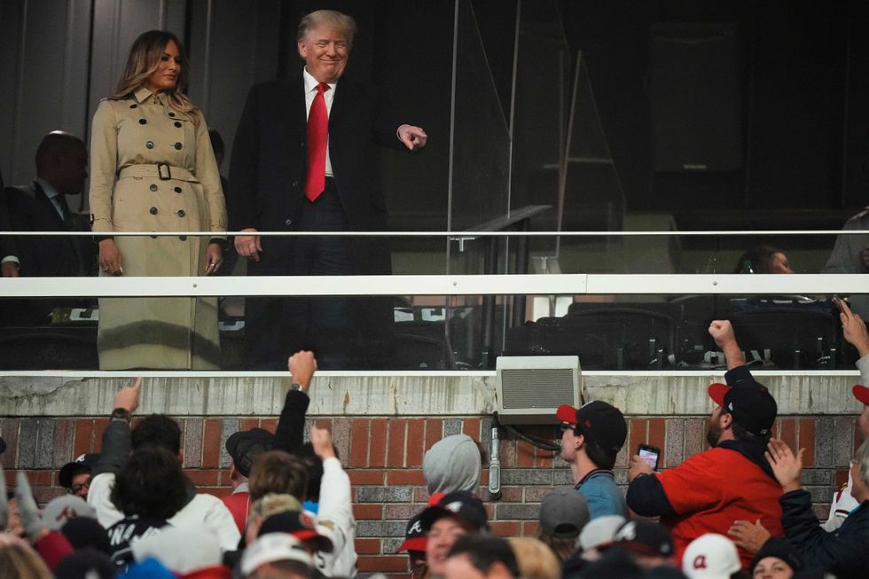 Former President Donald Trump and his wife Melania arrive for Game 4 of baseball