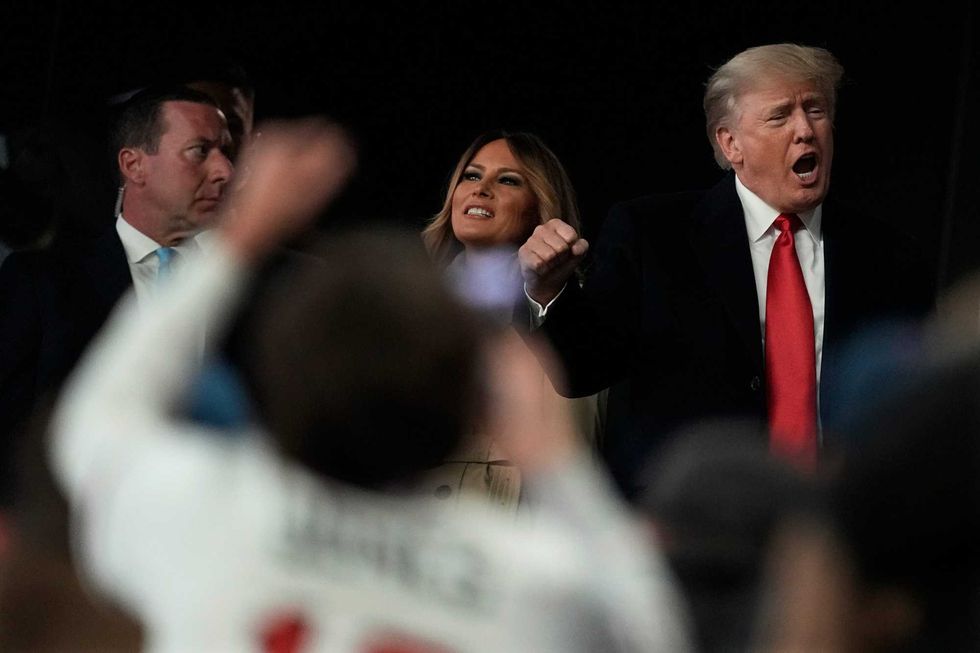Former President Donald Trump and his wife Melania arrive for Game 4 of baseball