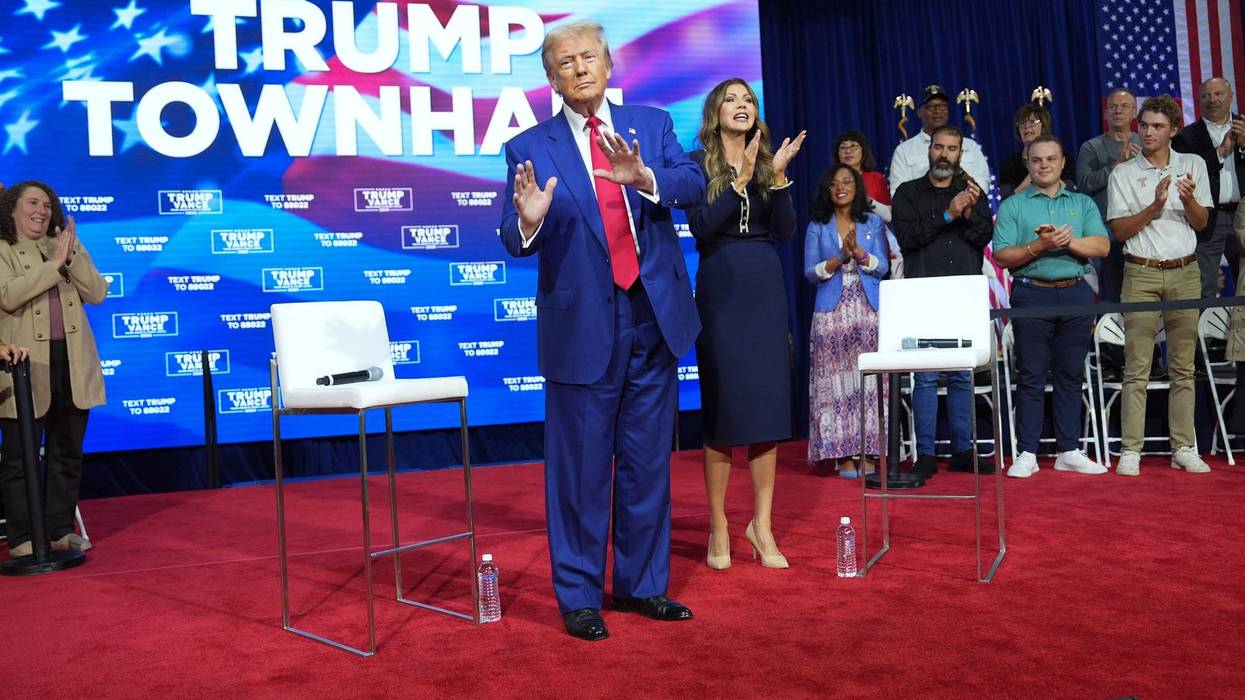 Former President Donald Trump dances on stage with South Dakota Gov. Kristi Noem during a town hall event held at the Greater Philadelphia Center & Fairgrounds, in Oaks, Pa. on Monday, Oct. 14, 2024.
