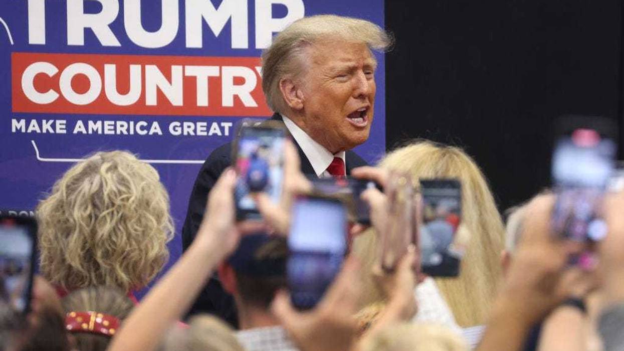 Former President Donald Trump greets supporters at a Team Trump volunteer leadership training event held at the Grimes Community Complex on June 01, 2023 in Grimes, Iowa. Trump delivered an unscripted speech to the crowd at the event before taking several questions from his supporters. (Photo by Scott Olson/Getty Images)