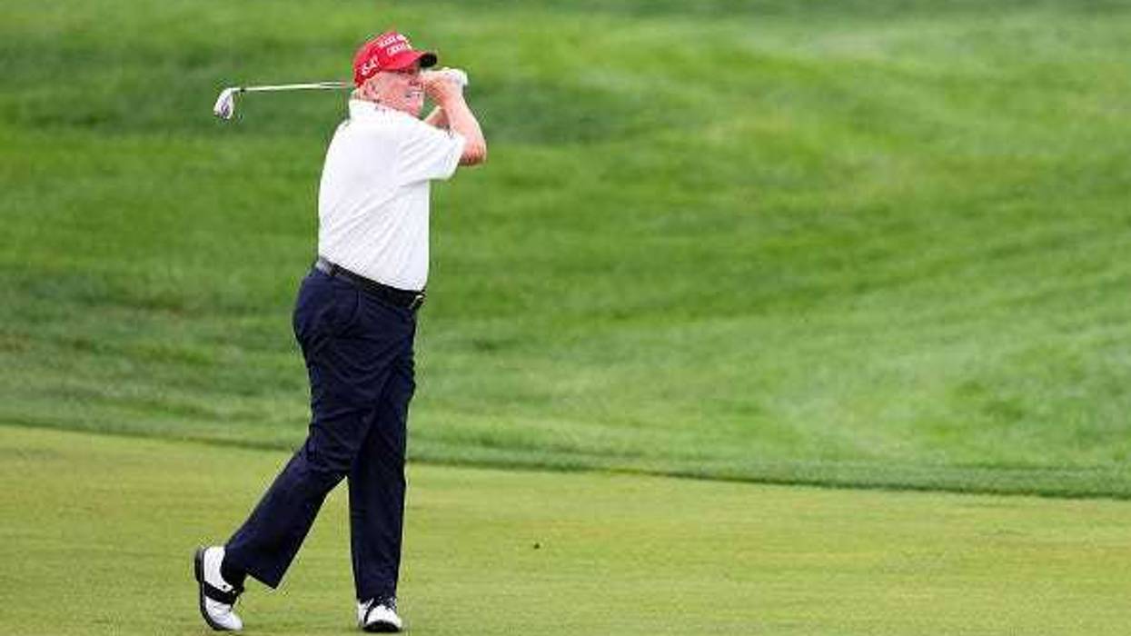 Former President Donald Trump hits his shot from the first fairway during the pro-am prior to the LIV Golf Invitational - Bedminster at Trump National Golf Club on August 10, 2023 in Bedminster, New Jersey.