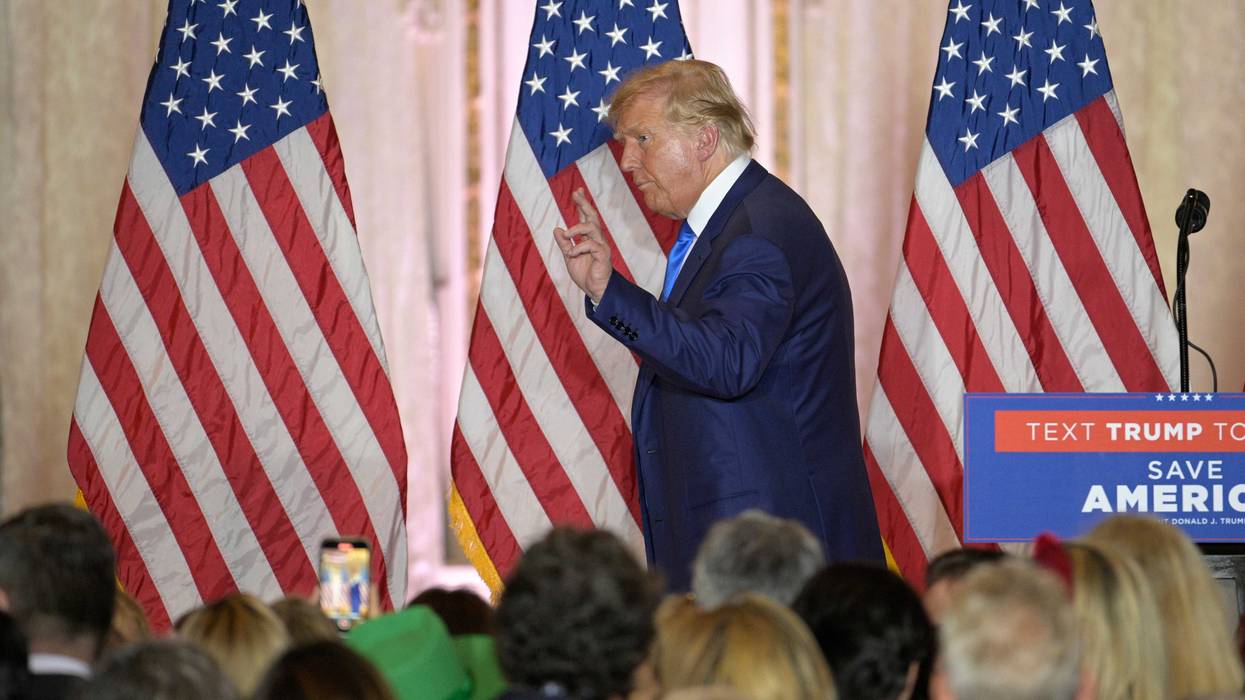 Former President Donald Trump, left, waves to guests during an election night party at Mar-a-Lago, Tuesday, November 8, 2022 in Palm Beach, Florida.