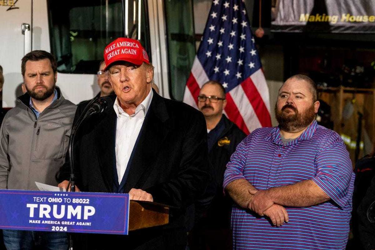 Former President Donald Trump stands next to a pallet of water before delivering remarks at the East Palestine Fire Department station on February 22, 2023 in East Palestine, Ohio.