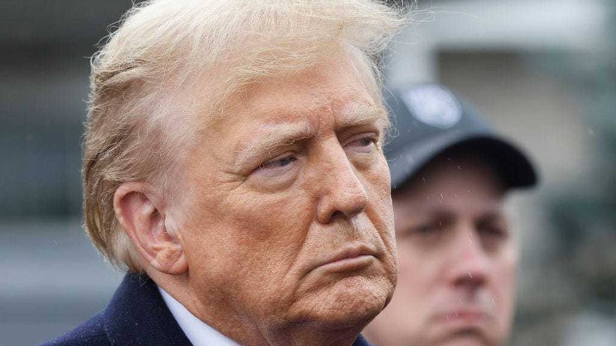 Former President Donald Trump stands silently after giving a brief statement after attending the wake for slain NYPD Officer Jonathan Diller at the Massapequa Funeral Home on March 28, 2024 in Massapequa, New York.