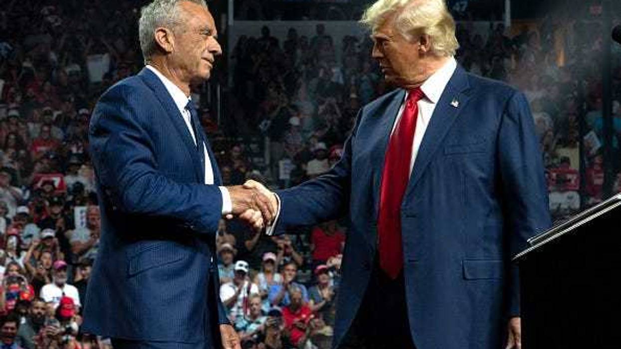 Former Republican presidential candidate Robert F. Kennedy Jr. and Republican presidential nominee, former U.S. President Donald Trump shake hands during a campaign rally at Desert Diamond Arena on August 23, 2024 in Glendale, Arizona.