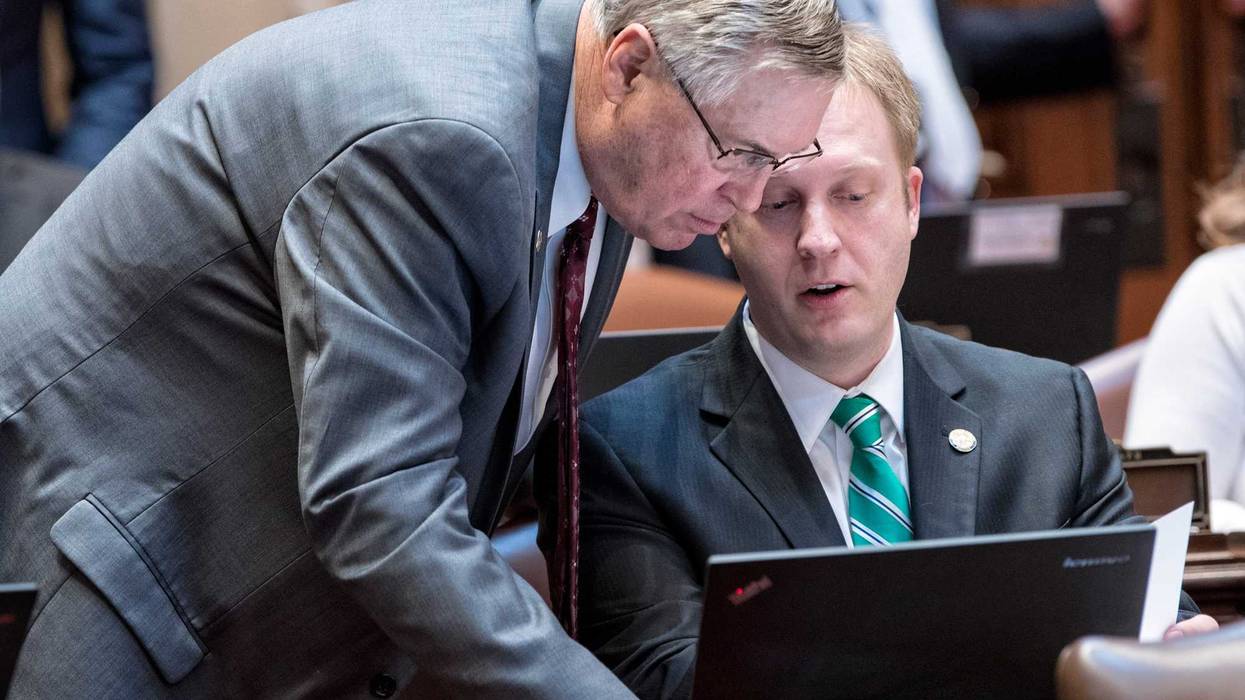 Former Republican State Senator Justin Eichorn (right) discusses senate business during a floor session prior to his resignation after charges were filed in an underage prostitution ring in Bloomington.