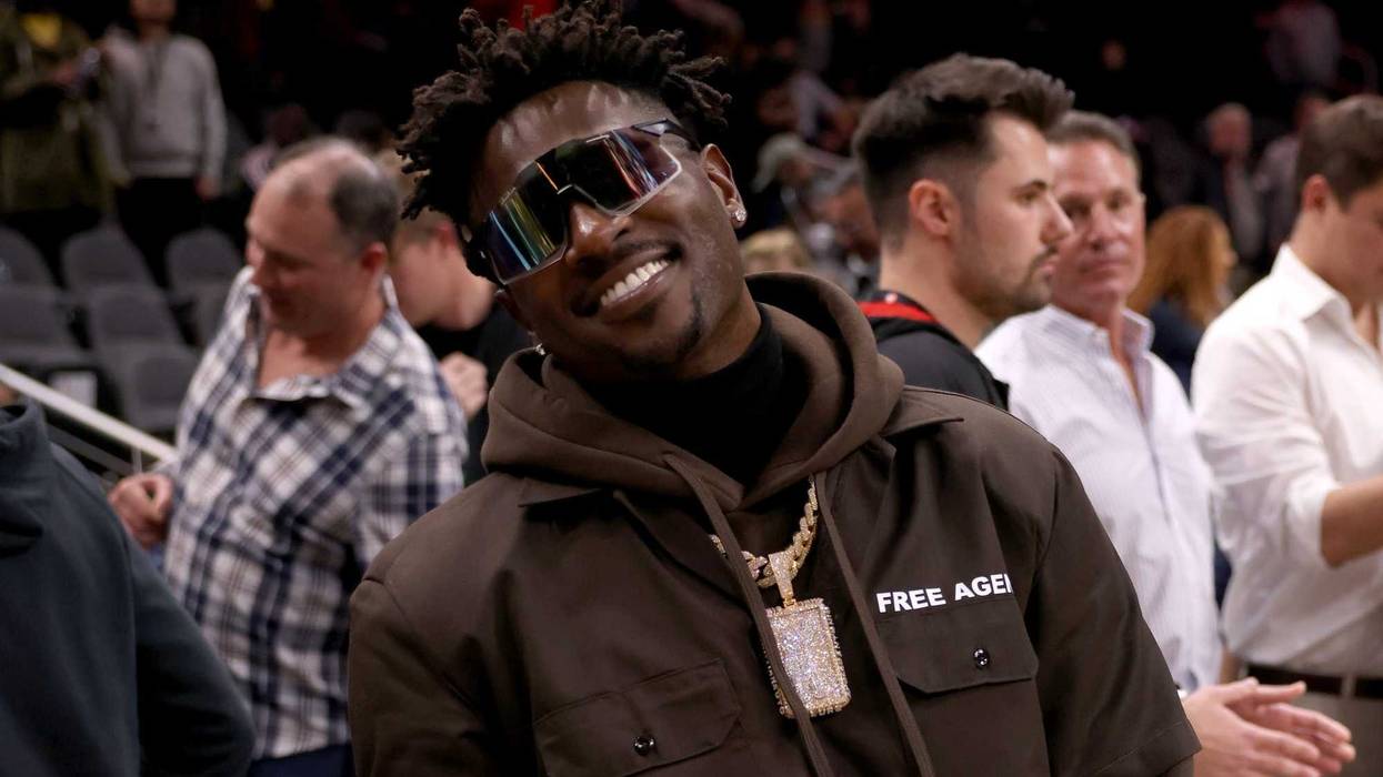Former Tampa Bay Buccaneers wide receiver Antonio Brown poses for photographers after the game between the Atlanta Hawks and the LA Clippers at State Farm Arena.