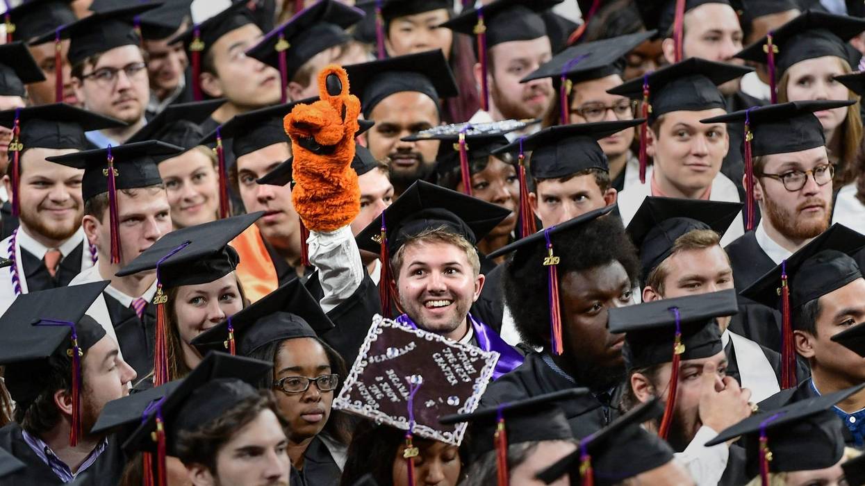 Former Tiger Cub mascot Nicholas Tourville of Fort Mill, Bachelor of Science in Bioengineering, points up with a tiger cub glove during Clemson University Fall graduation at Littlejohn Coliseum in Clemson Thursday, December 19, 2019. Clemson University Fa