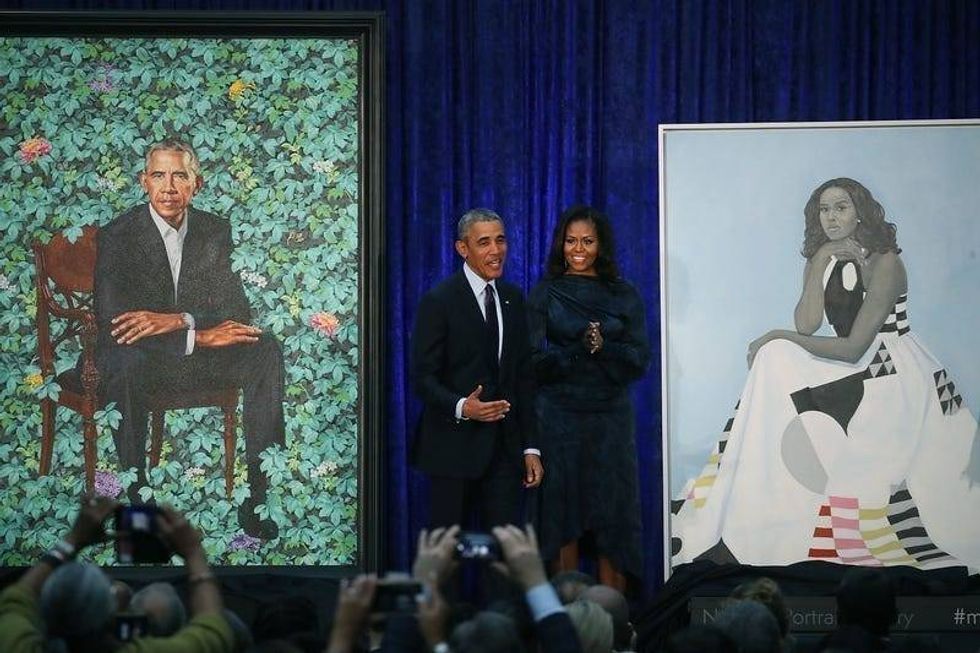 Former U.S. President Barack Obama and former first lady Michelle Obama stand next to their newly unveiled portraits during a ceremony at the Smithsonian