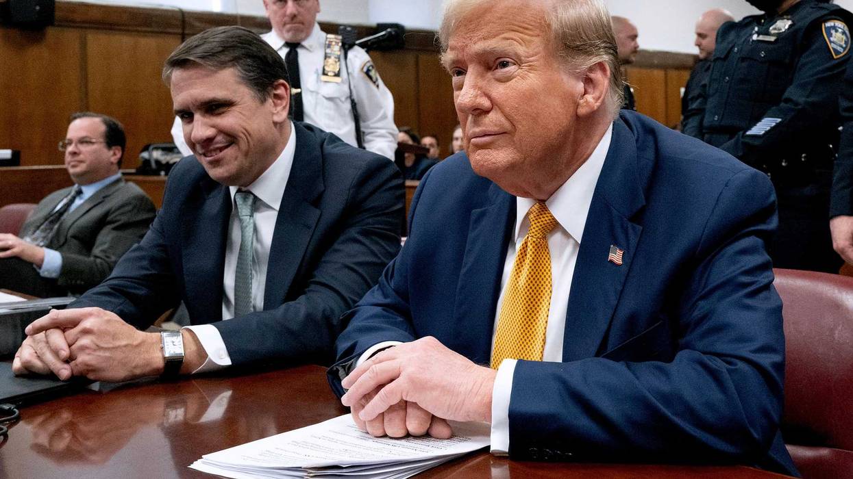 Former U.S. President Donald Trump (C) sits next to his lawyers Todd Blanche (L) and Emil Bove as he arrives for his trial for allegedly covering up hush money payments linked to an extramarital affair with Stormy Daniels, at Manhattan Criminal Court on May 14, 2024 in New York City.
