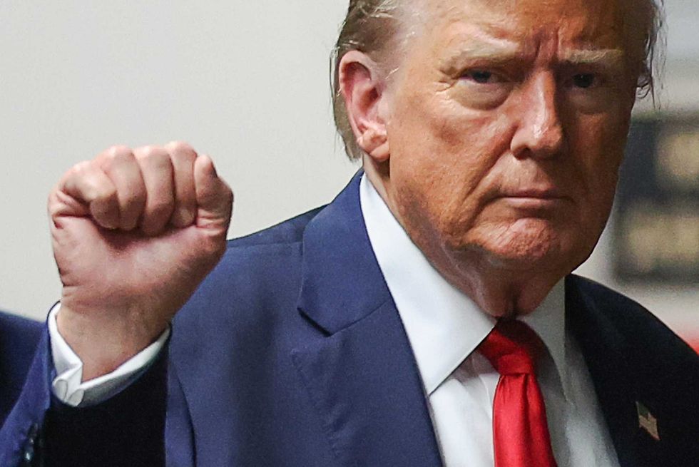 Former U.S. President Donald Trump gestures as he returns to court after a lunch break, during his trial for allegedly covering up hush money payments at Manhattan Criminal Court on May 16, 2024 in New York City.
