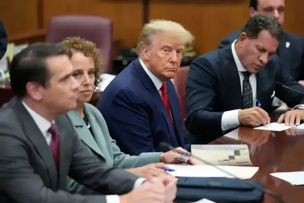 Former U.S. President Donald Trump sits at the defense table with his defense team in a Manhattan court on April 4, 2023, in New York City.