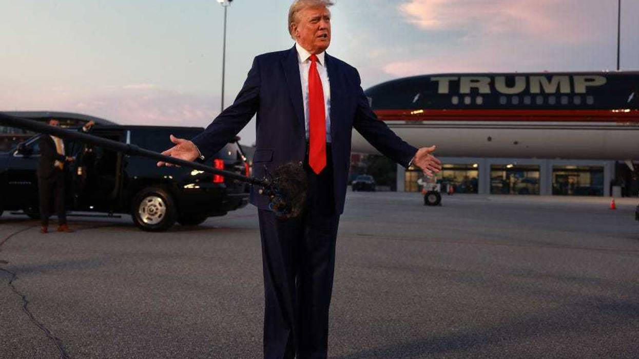 Former U.S. President Donald Trump speaks at Atlanta Hartsfield-Jackson International Airport after surrendering at the Fulton County jail on August 24, 2023 in Atlanta. Trump was booked on multiple charges related to an alleged plan to overturn the results of the 2020 presidential election in Georgia.
