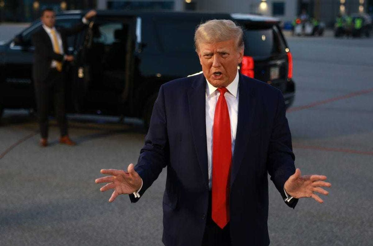 Former U.S. President Donald Trump speaks to the media at Atlanta Hartsfield-Jackson International Airport after being booked at the Fulton County jail on August 24, 2023 in Atlanta, Georgia.