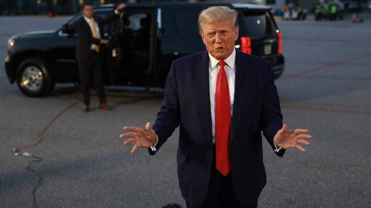 Former U.S. President Donald Trump speaks to the media at Atlanta Hartsfield-Jackson International Airport after surrendering at the Fulton County jail on August 24, 2023 in Atlanta, Georgia. Trump was booked on multiple charges related to an alleged plan to overturn the results of the 2020 presidential election in Georgia. (Photo by Joe Raedle/Getty Images)