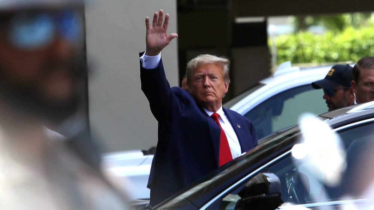 Former U.S. President Donald Trump waves as he makes a visit to the Cuban restaurant Versailles after he appeared for his arraignment on June 13, 2023 in Miami, Florida.