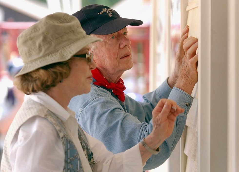 Former U.S. President Jimmy Carter and his wife Rosalyn attach siding to the front of a Habitat for Humanity home being built June 10, 2003 in LaGrange, Georgia. More than 90 homes are being built in LaGrange; Valdosta, Georgia; and Anniston, Alabama by volunteers as part of Habitat for Humanity International