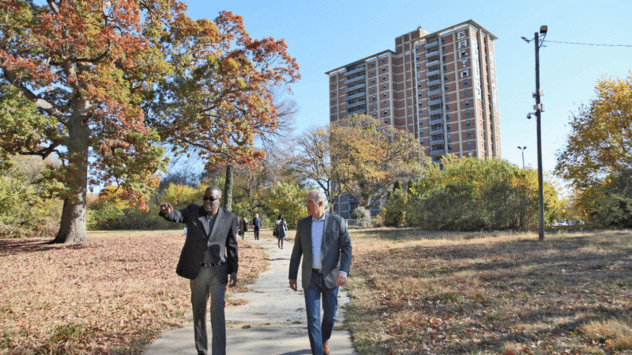 Former U.S. Sen. Bob Casey and Philadelphia Housing Authority President Kelvin Jeremiah are shown last year walking the campus of Westpark Apartments, a public housing site that is being updated into modern, affordable housing