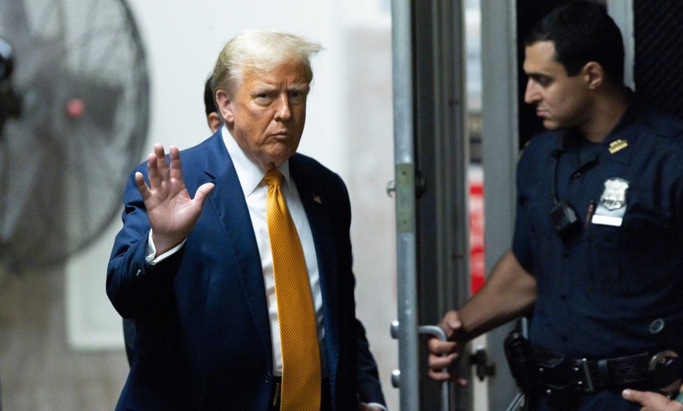 Former US President Donald Trump returns to the courtroom after a break in his trial for allegedly covering up hush money payments at Manhattan Criminal Court on May 14, 2024 in New York City.