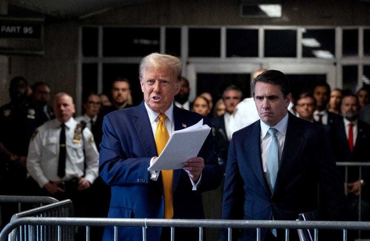Former US President Donald Trump, with lawyer Todd Blanche (R), speaks to the media as he arrives for his trial for allegedly covering up hush money payments linked to an extramarital affair with Stormy Daniels, at Manhattan Criminal Court on May 14, 2024 in New York City.