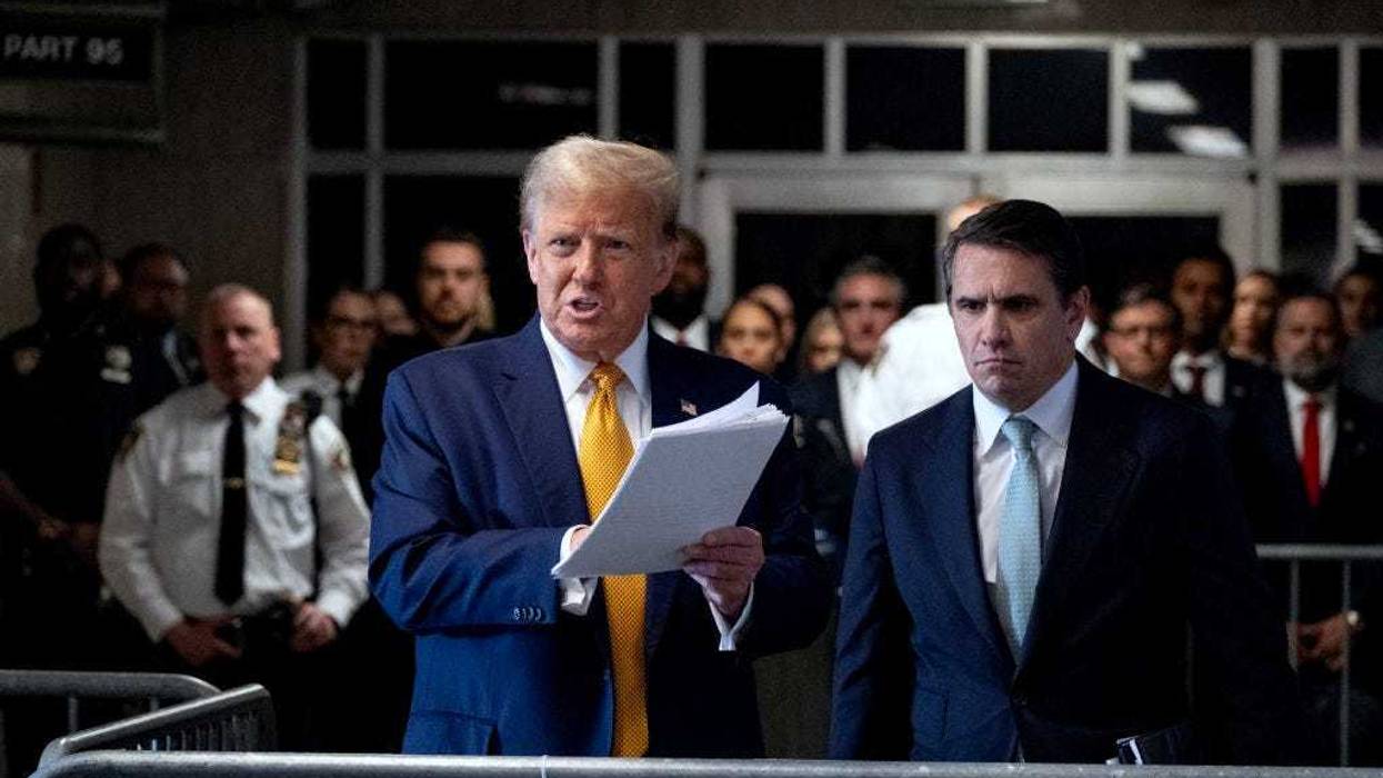 Former US President Donald Trump, with lawyer Todd Blanche (R), speaks to the media as he arrives for his trial for allegedly covering up hush money payments linked to an extramarital affair with Stormy Daniels, at Manhattan Criminal Court on May 14, 2024 in New York City.