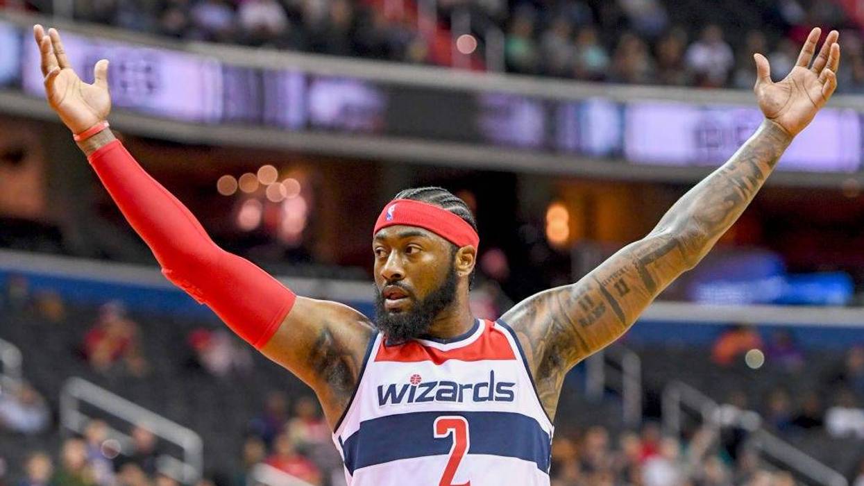 Former Washington Wizards guard John Wall (2) celebrates a three-pointer against the Miami Heat at Capital One Arena. (Photo