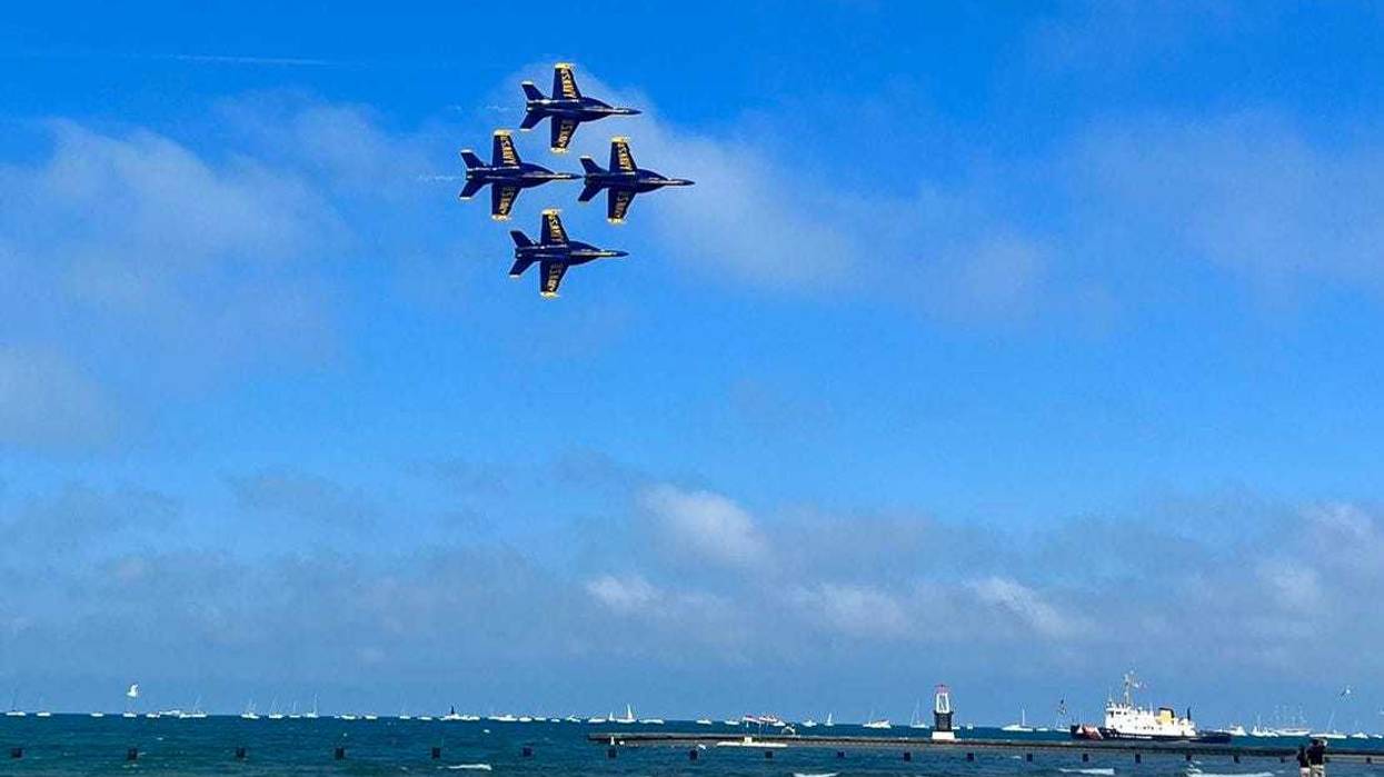Four jets fly in a diamond formation over Lake Michigan