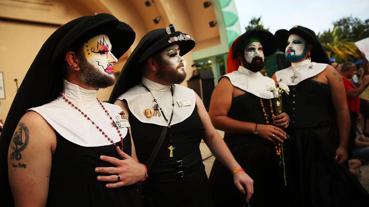 four people in sleeveless nun outfits with colorful costume makeup