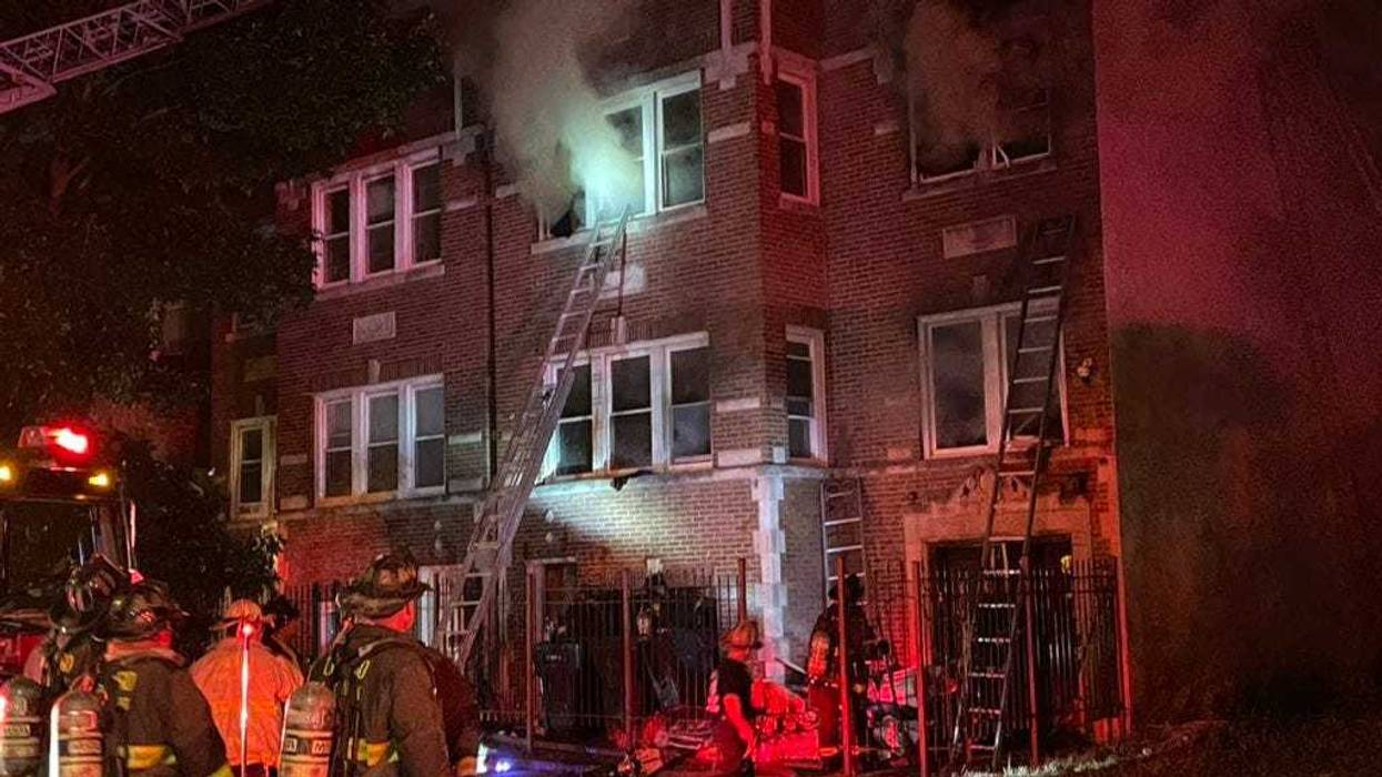 Four people were injured, including a Chicago police officer, as residents were forced to jump from an apartment building fire in Englewood on the South Side.
