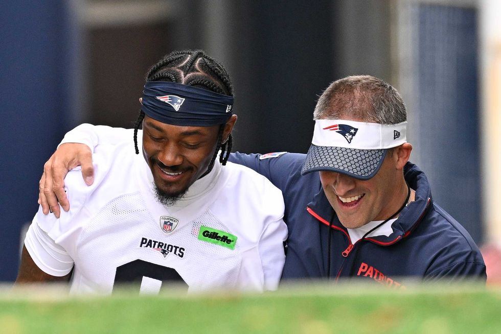 Foxborough, MA, USA; New England Patriots offensive coordinator Josh McDaniels (r) walks to the practice field with his arm around wide receiver Stefon Diggs (8) before minicamp at Gillette Stadium.