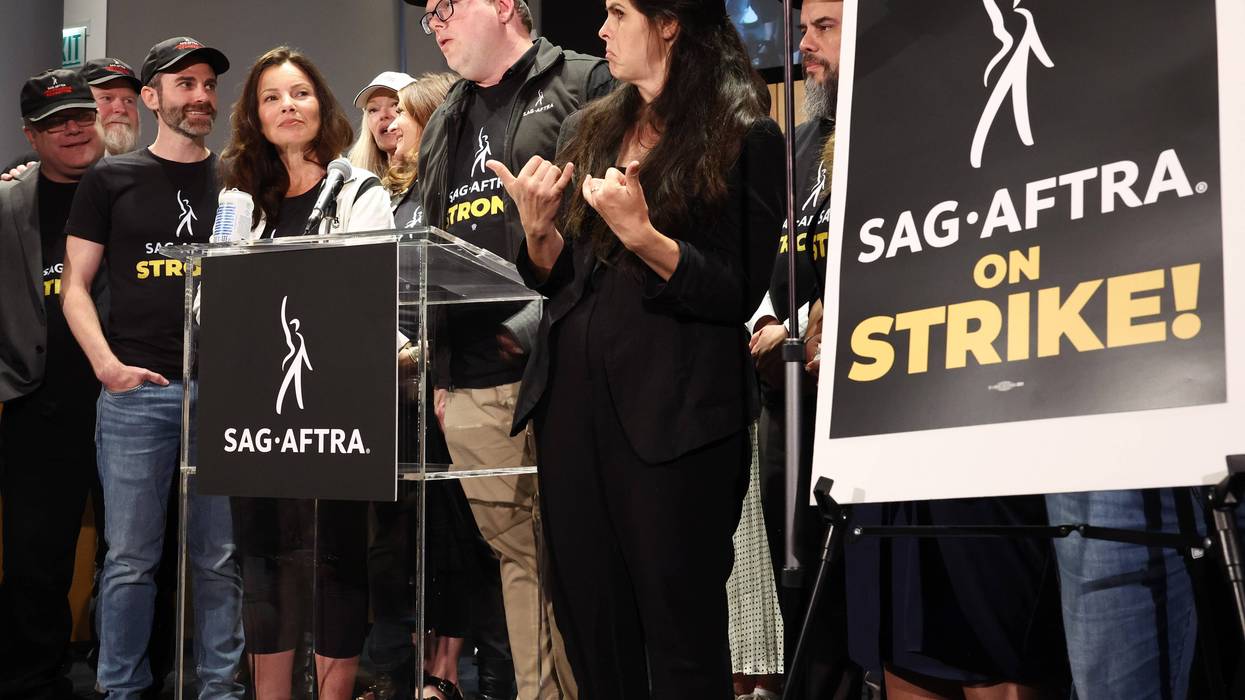 fran drescher and other sag-aftra members at press conference with sign that says sag-aftra on strike